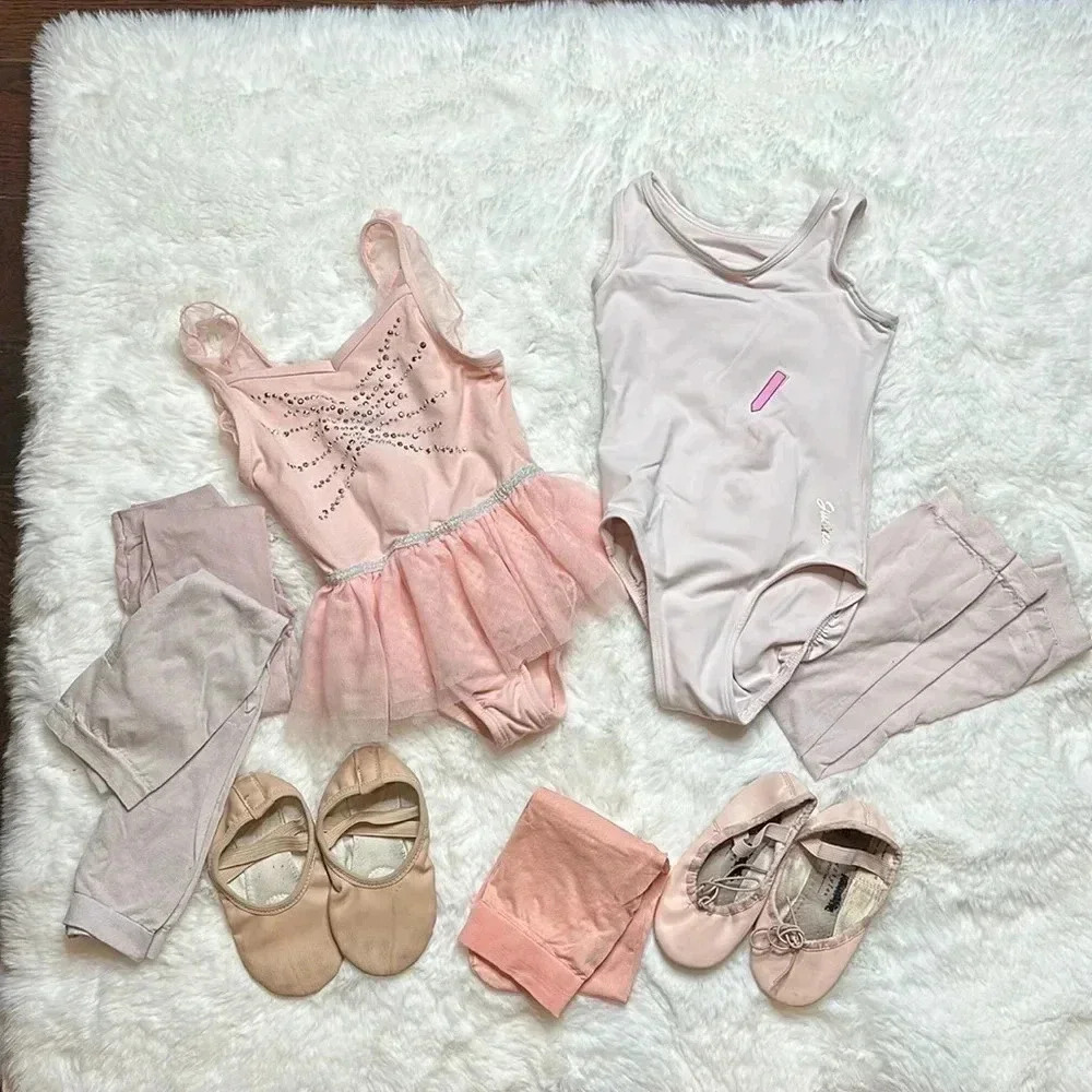 Pink mixed dance attire two bodysuits two pairs of ballet shoes.